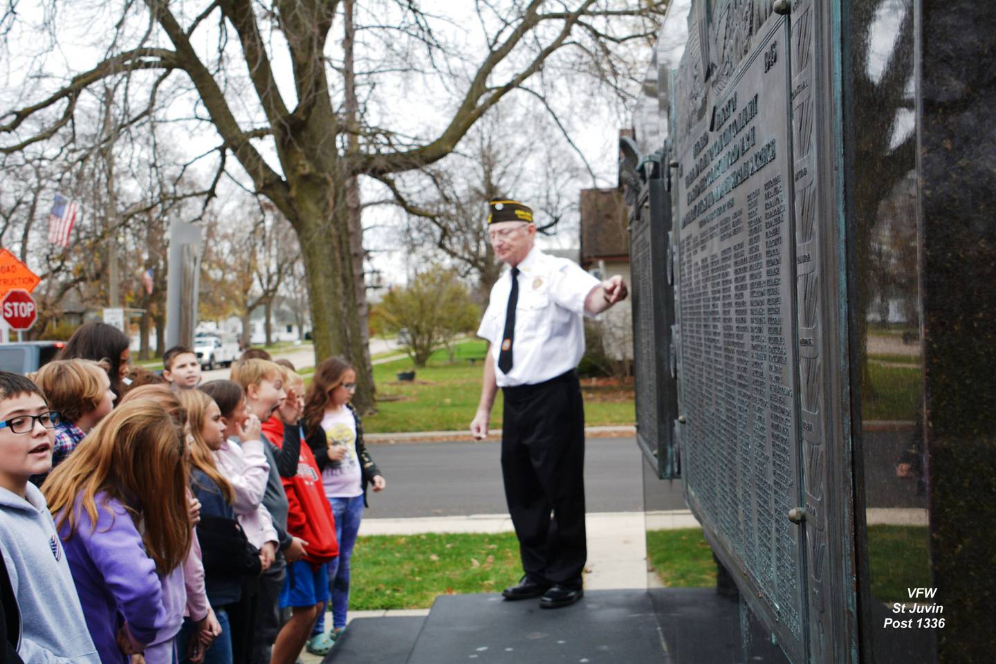 Jr. Vice-Commander and Air Force vet Jim Richards answers question from the students about the Community Veterans Memorial.