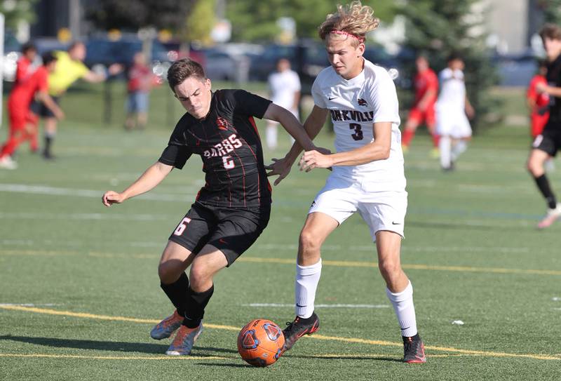 DeKalb's Landon Weishaar tries to hold off Yorkville's Caden Nadler during their game Thursday, Aug. 25, 2022, in the Barb Cup at the Northern Illinois University Outdoor Recreation Sports Complex.