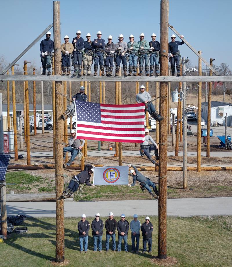 ComEd's Joliet Training Center Single Phase Class poses on training poles.