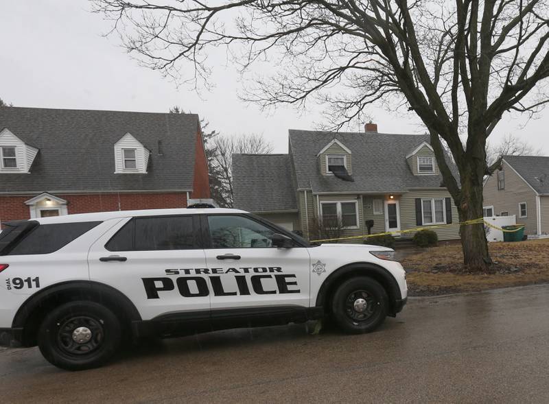 A Streator Police officer sits outside a home in the 1100 block of East Elm Street on Tuesday, March 4, 2025 in Streator.