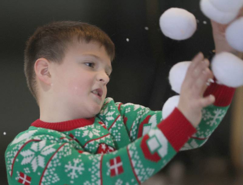 Lincoln Harris of La Salle, throws snow balls during the Miracle on First Street at Ax Church on Saturday, Dec. 6, 2025 in La Salle.