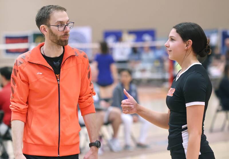 DeKalb’s Gwen Pfile gives a thumbs-up to her coach Zak Effler during a break in her match Friday, May 12, 2023, during her match against Carissa Chen from the Illinois Math and Science Academy in the IHSA State Badminton Finals at DeKalb High School.