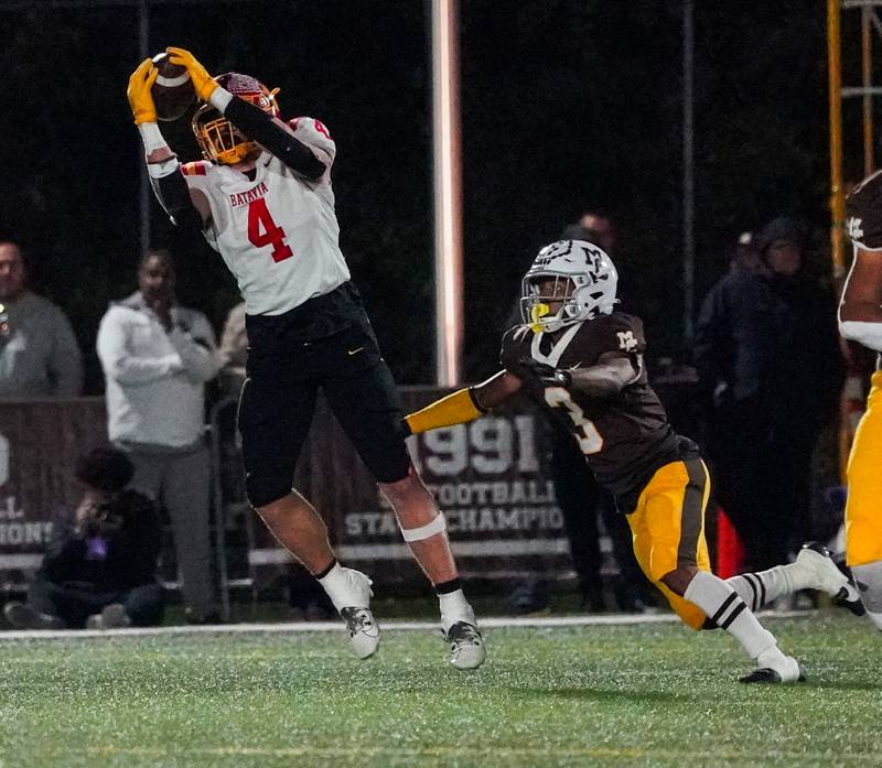 Batavia's Charlie Whelpley (4) catches a pass against Mt. Carmel's Le'Javier Payne (3) during a class 7A semifinal football playoff game at Mt. Carmel High School in Chicago on Saturday, Nov 18, 2023.