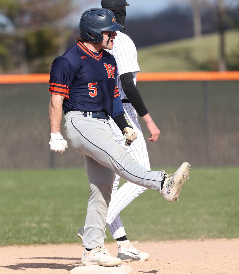 Naperville North's Zach Bava celebrates after hitting a double Tuesday, April 15, 2025, during their game at DeKalb High School.