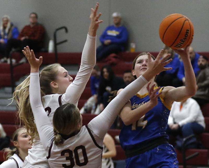 Johnsburg's Summer Toussaint (right) drives to the baker against Marengo's Dayna Carr (left) and Macy Noe (center) during a Kishwaukee River Conference basketball game on Saturday, Feb. 1, 2025, at Marengo High School.