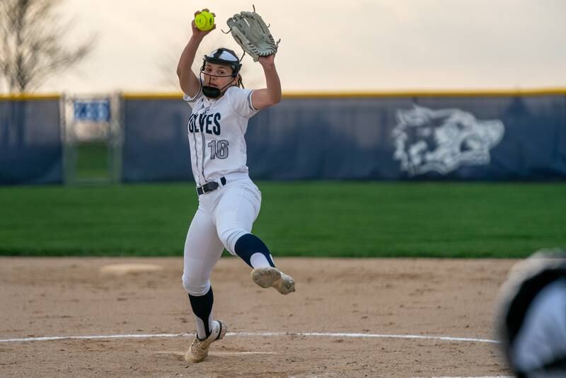 Oswego East's Nicole Stone (16) delivers a pitch against Oswego during a softball game at Oswego East High School on Wednesday, April 19, 2023.