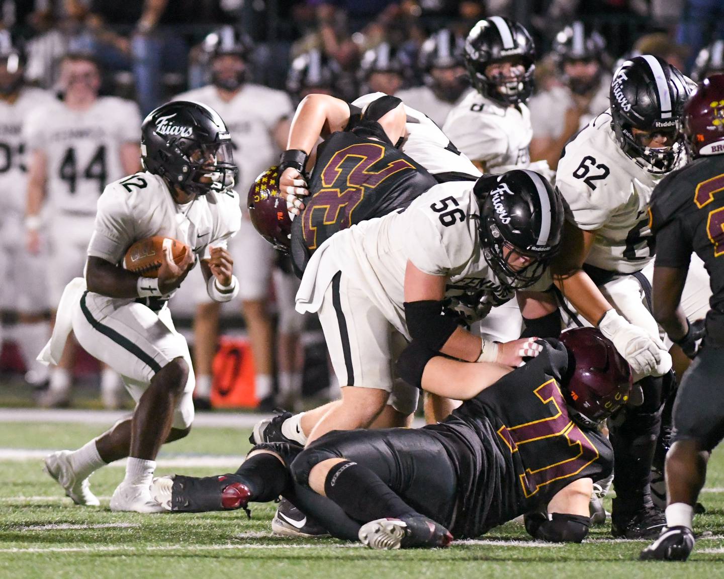 Fenwick's Jamen Williams (12) runs the ball during the game on Friday Sept. 19, 2025, while traveling to take on Montini Catholic High School.