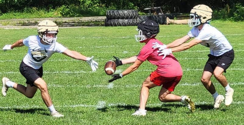 Ottawa receiver Levi Sheehan (center) makes a grab between St. Bede defenders Nathan Lough (left) and Callan Hueneburg during Thursday's 7-on-7 camp at St. Bede Academy.