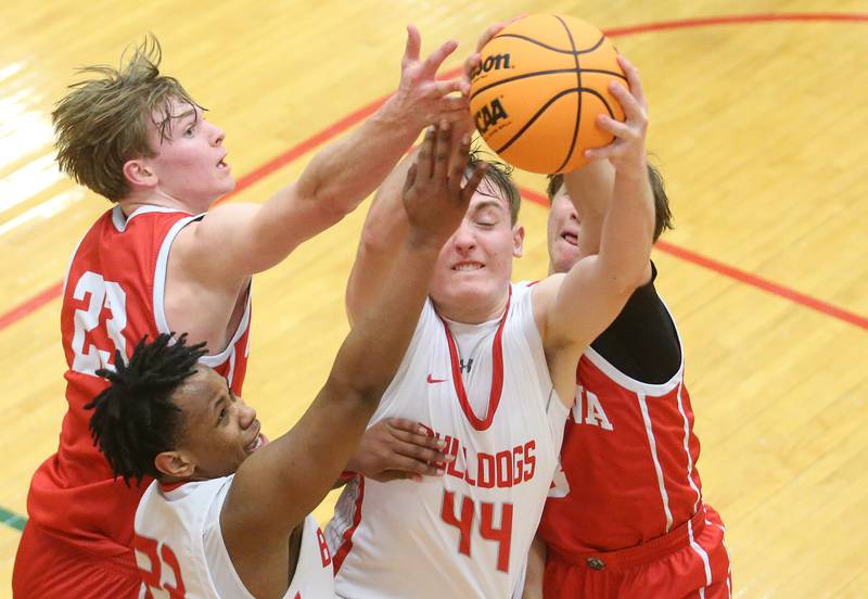 Streator's Nolan Lukach grabs a rebound over Ottawa's Owen Sanders and Connor Diderich during the Class 3A Regional semifinal game on Wednesday, Feb. 26, 2025 in Sellett Gymnasium at L-P High School.