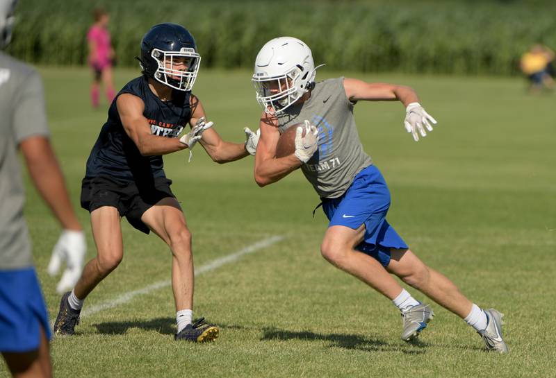 Burlington Central offense run the ball against Oswego during a 7 on 7 football in Maple Park on Tuesday, July 12, 2022.