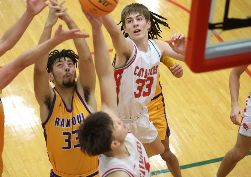 L-P's Gavin Stokes and Erick Sotelo grabs a rebound over Rantoul's Tysean Moody on Friday, Dec. 19, 2025 in Sellett Gymnasium at L-P High School.