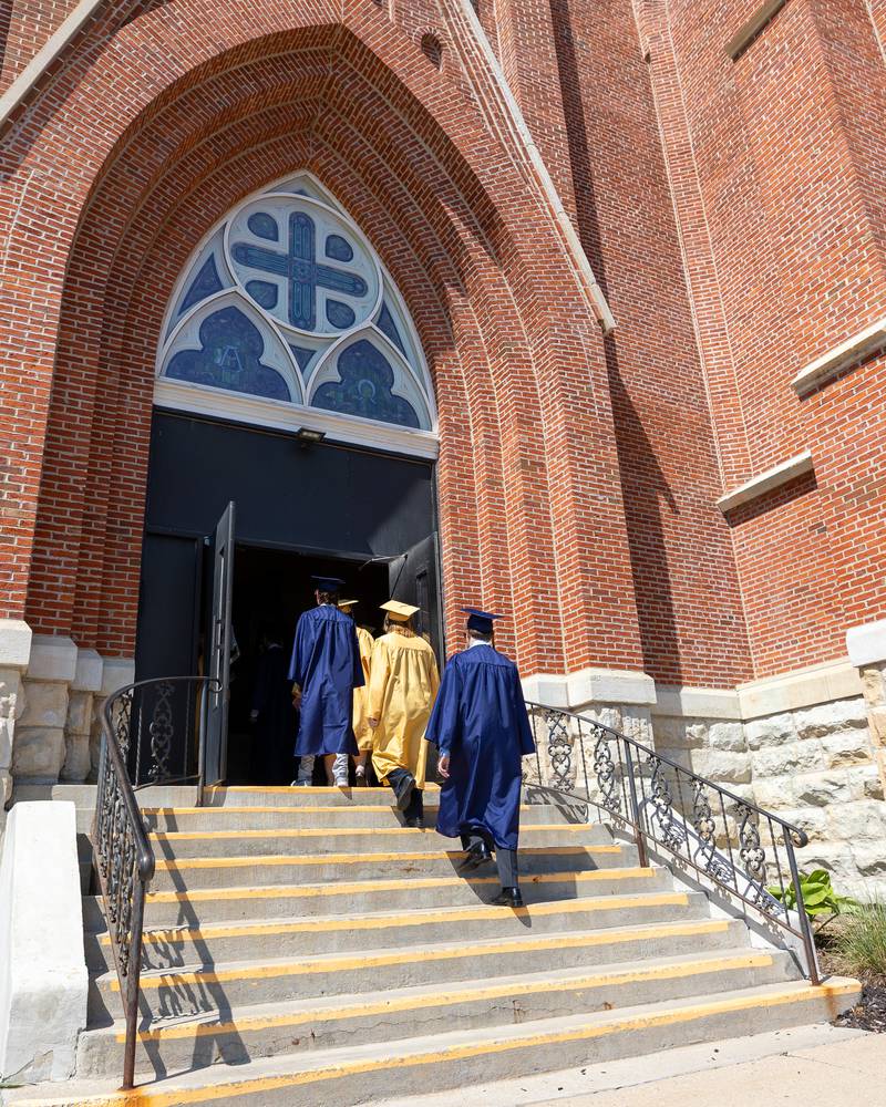 Class of 2026 Marquette Academy Graduates walk up stairs into St. Columba Church before the Graduation Ceremony on May 24, 2026 in Ottawa.