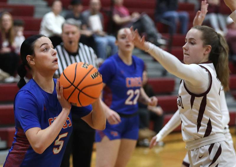 Genoa-Kingston's Zoe Boylen shoots the ball as Marengo's Katie Hanson close in during an IHSA Class 2A Marengo Regional semifinal girls basketball game on Monday, Feb. 16, 2026, at Marengo High School.