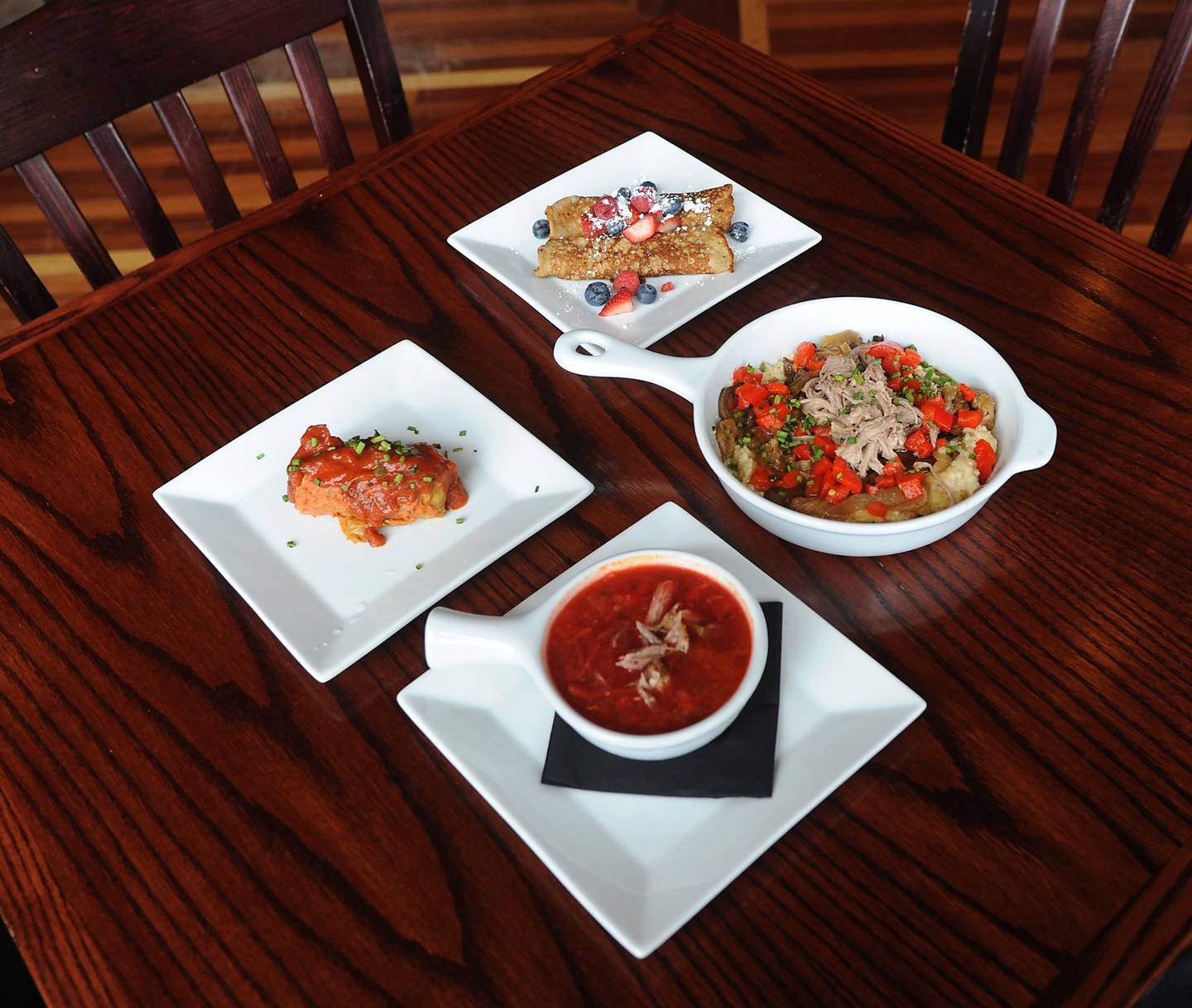 The  Ukrainian meal special made for the Bold American Fare restaurant in Algonquin by sous-chef Roman Tsallagov includes borscht, front; holubtsi, center left; banosh, center right; and mlyntsi, back. All proceeds from the four-course meal are donated to Razom for Ukraine.
