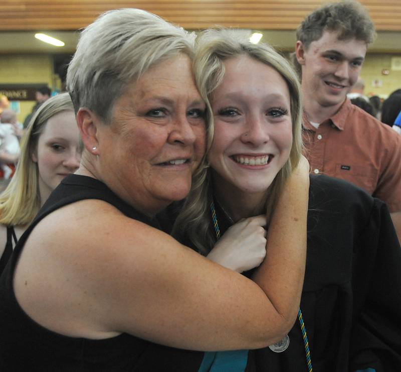 Jen Sword hugs her daughter, Maggie, after she graduated Saturday, May 14, 2022, during the graduation ceremony at Woodstock North High School.