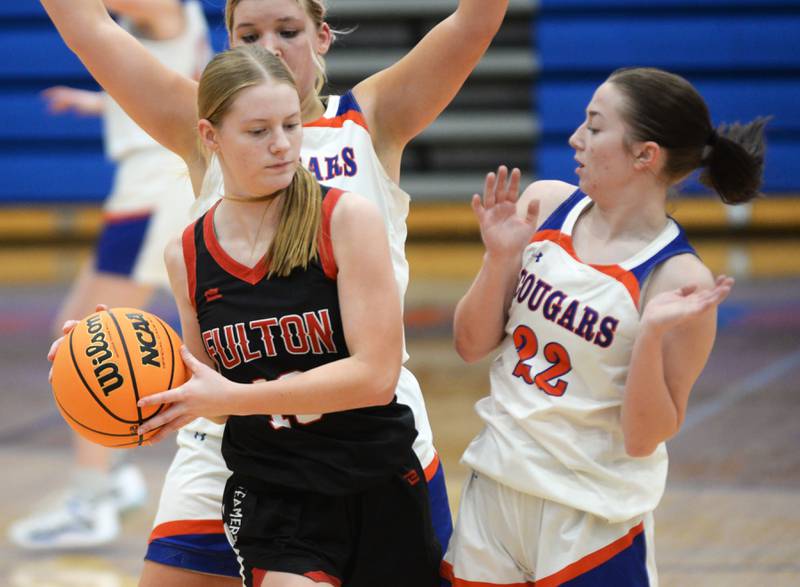 Fulton's Hailey Smither (13) pulls the ball away from Eastland's Sienna Peterson (22) during a Friday, Dec. 13, 2024 game at Eastland High School in Lanark.