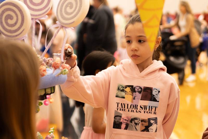 Child picks lollipop at the annual Easter Egg hunt on Saturday, April 12, 2025 at Hall High School in Spring Valley.