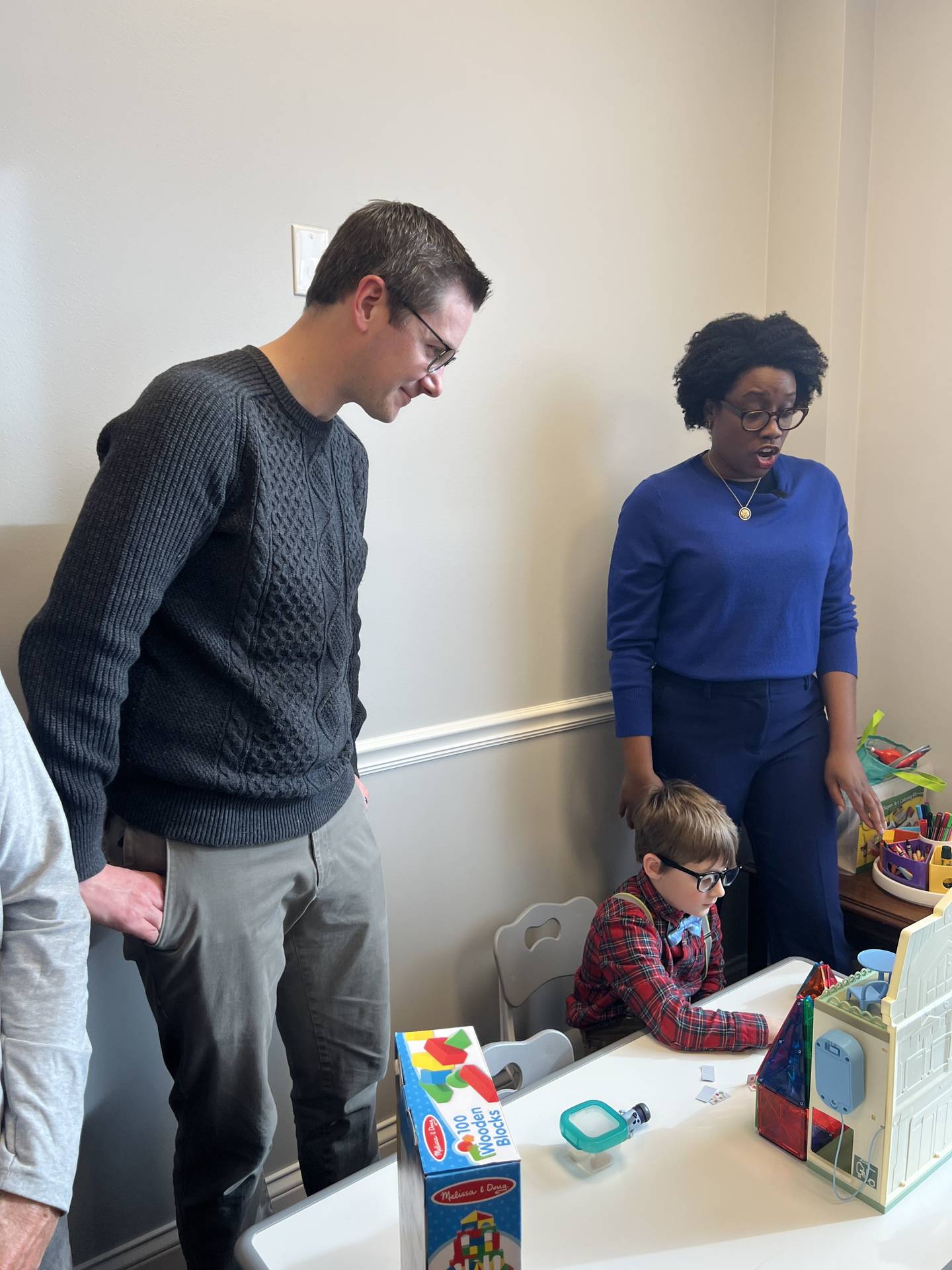 U.S. Rep. Lauren Underwood, D-Naperville, reacts to a magnetic creation by Sycamore child Harvey Kleinfeldt, alongside his father Brian Kleinfeldt, inside her DeKalb office on Jan. 17, 2026.