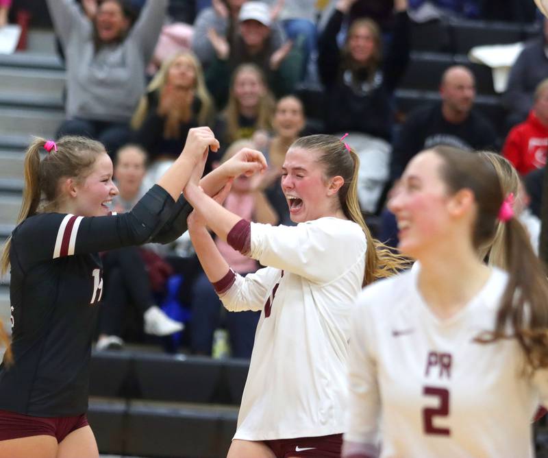 Prairie Ridge’s Tegan Vrbancic, left, and Addy Grider celebrate a late point in a win over St. Viator in IHSA Class 3A Super-Sectional girls volleyball at Streamwood High School in Streamwood on Monday, November 10, 2025.
