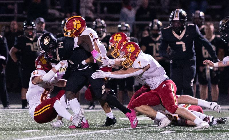 Glenbard North's Elliston Damarion (14) carries the ball and is brought down by four Batavia defenders during a football game at Glenbard North High School in Carol Stream on Friday, Sep 23, 2022.