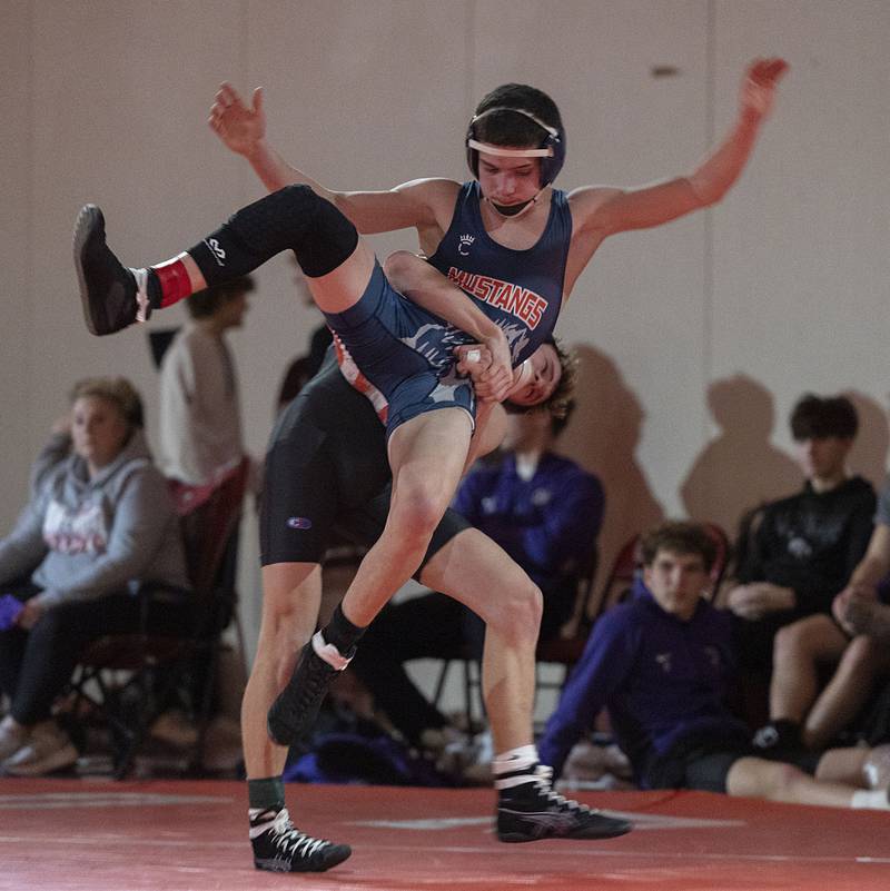 Dixon’s Jack Ragan lifts Morrison’s Cael Wright in the 120 pound weight class in the Class 1A wrestling sectionals at Oregon.