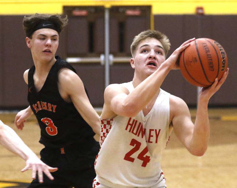 Huntley's Aiden Wieczorek, right, drives toe basket in front of McHenry’s Zachary Manessduring a IHSA Class 4A Boys Regional basketball game Wednesday, Feb. 23, 2022, between Huntley and McHenry at Jacobs High School.