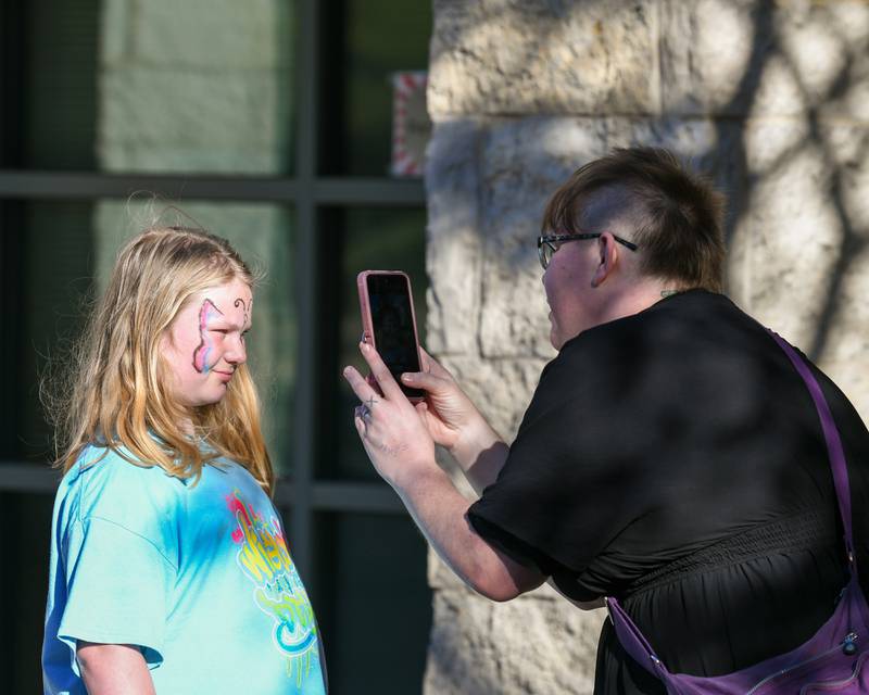 Kirstie Glickstein who is like an aunt to Lilly Haynes 11, of Sycamore takes a photo after Lilly gets her face painted on Sunday Oct. 12, 2025,  during the DeKalb County 4-H carnival held at the DeKalb County Farm Bureau in Sycamore.