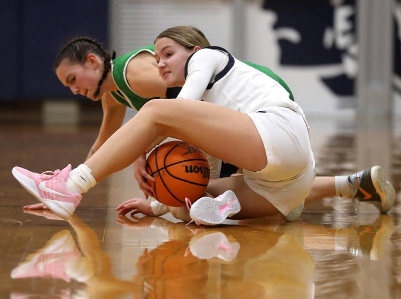 Crystal Lake South's Mallory Glover battles with \cg20 for a loose ball during a Fox Valley Conference girls basketball game on Tuesday, Dec. 2, 2025, at Cary-Grove High School in Cary.