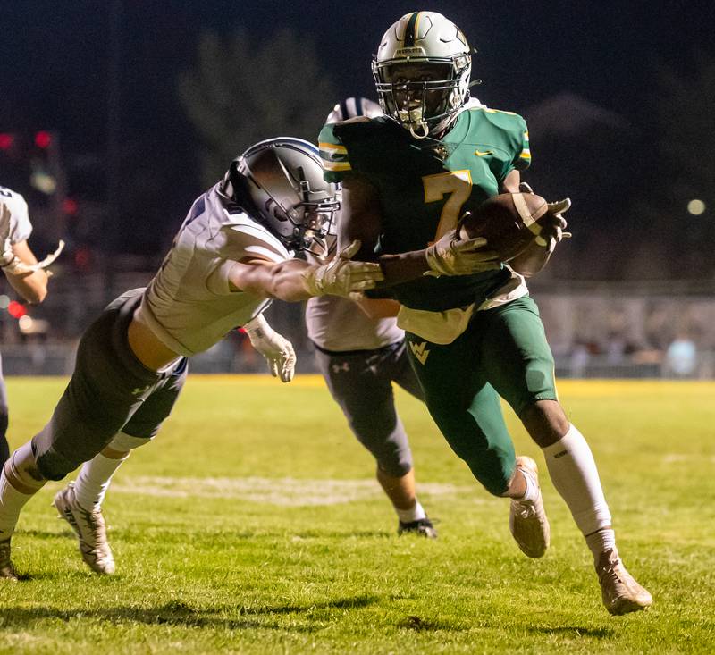 Waubonsie Valley's Tyler Threat (7) carries the ball for a touchdown against Oswego East during a football game at Waubonsie Valley High School in Aurora on Friday, Aug. 25, 2023.