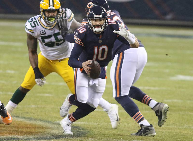 Chicago Bears quarterback Mitchell Trubisky (10) scrambles away from Green Bay Packers outside linebacker Za'Darius Smith (55) during their game Sunday at Soldier Field in Chicago.