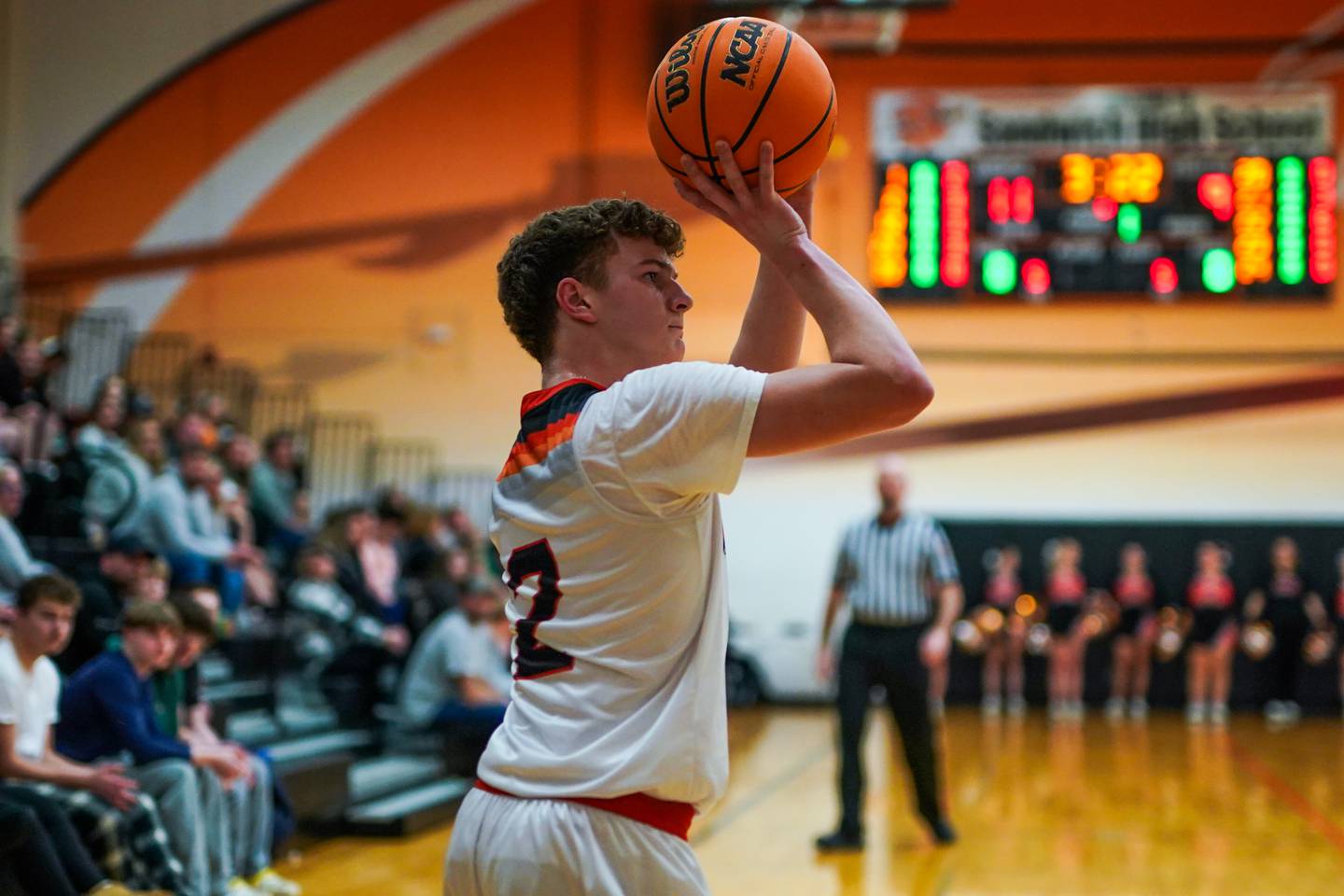 Sandwich's Griffin Somlock (2) shoots a three pointer from the corner during a basketball game against Morris at Sandwich High School on Friday, January 3, 2025.