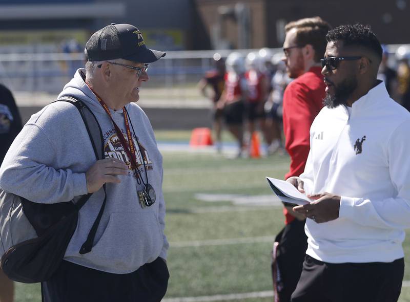 Richmond-Burton Head Coach Mike Noll talks with University of Wyoming cornerbacks coach JB Hall at the Northern Burbs Football Showcase on Monday, May 4, 2026, at Johnsburg High School. Over 165 players from 15 teams demonstrated their football skills to over 60 college coaches.