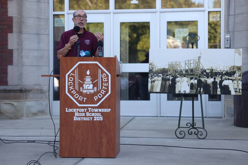 Lockport Township High School District 204 Superintendent Dr. Robert McBride stand by a vintage photo of the construction of the central campus at the reopening celebration of the Lockport High School Central Campus on Friday, Aug. 16, 2024.