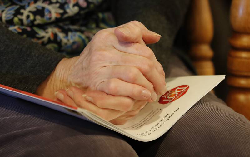 Bette Chwalisz, a retired teacher, clasps her hands after reading a book Thursday, Feb, 20, 2025, at Read Between The Lynes in Woodstock during the bookshop's weekly story time.