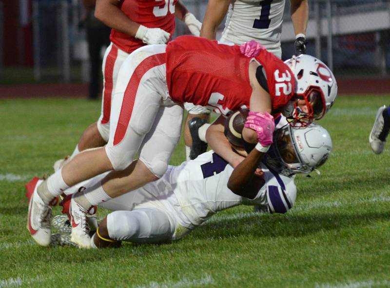 Oregon's Jakob Moser (32) is tackled by a Rockford Lutheran player on Friday, Sept. 5, 2025 at Landers-Loomis Field in Oregon.