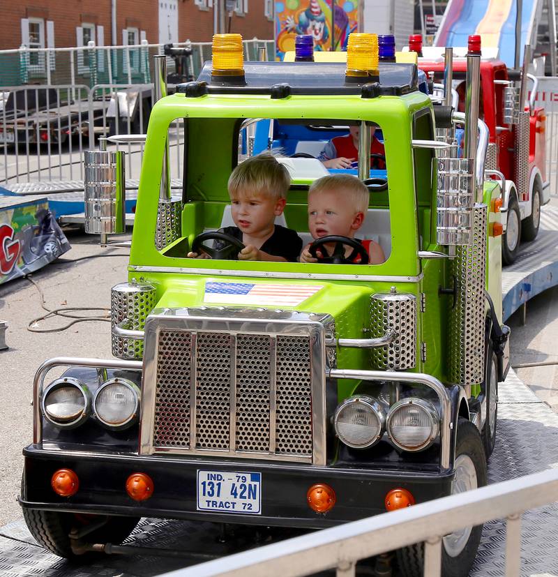 Steele and Payne Works of Batavia have fun in a carnival ride at the Windmill City Festival in Batavia on Saturday, July 13, 2024 in Batavia.