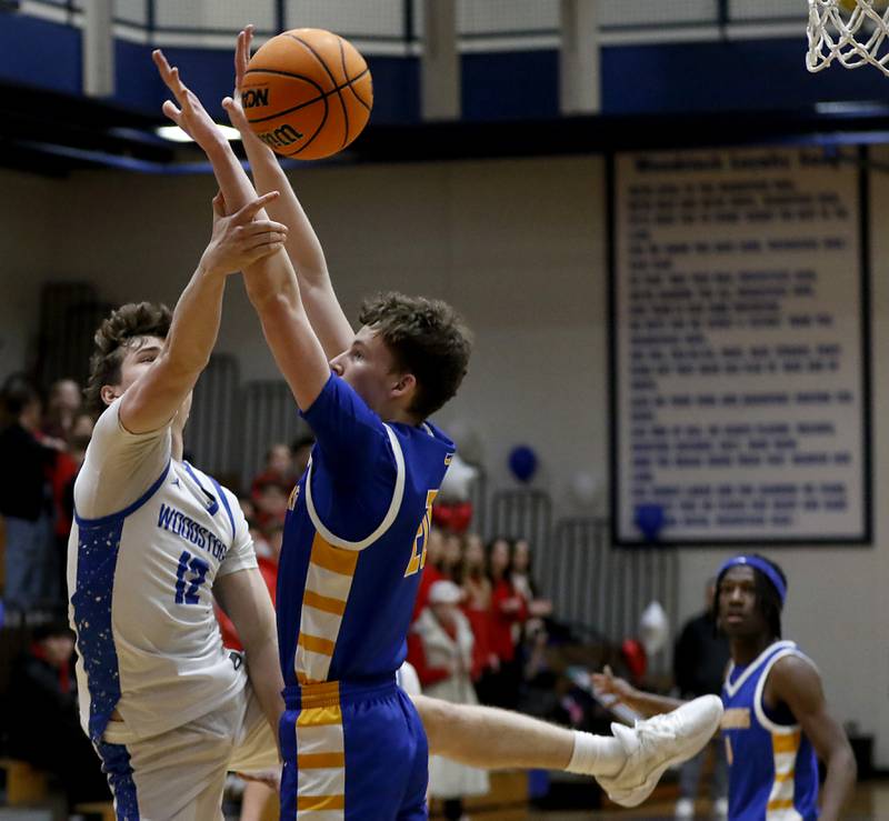 Woodstock's Charlie Walrod tries to shoot the ball around the defense of Johnsburg's Josh Kaunas during a Kishwaukee River Conference basketball game on Friday,  Feb. 14, 2025, at Woodstock High School.