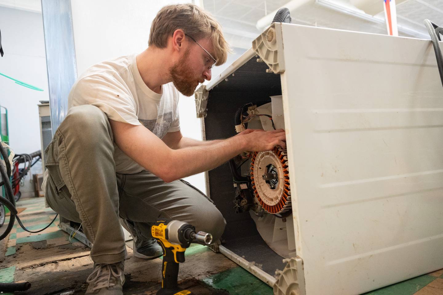 Kishwaukee College appliance repair technician student Jonathan Doty working on an appliance during class.