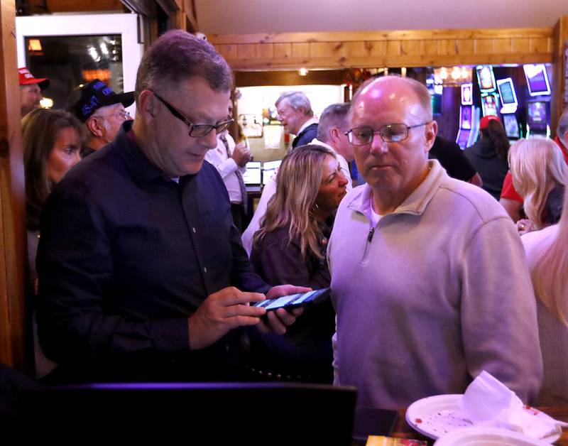 McHenry County Board Chairman Michael Buehler, left, and Coroner  Michael Rein watch election returns during a Republican watch party on Tuesday, Nov. 5, 2024, at Niko's Red Mill Tavern in Woodstock.