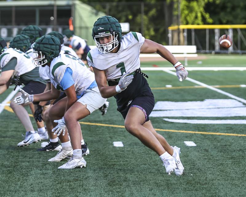 Brady Johnson goes into motion as the ball is snapped at Glenbard West football practice, Wednesday, Aug 21, 2025  in Glen Ellyn.