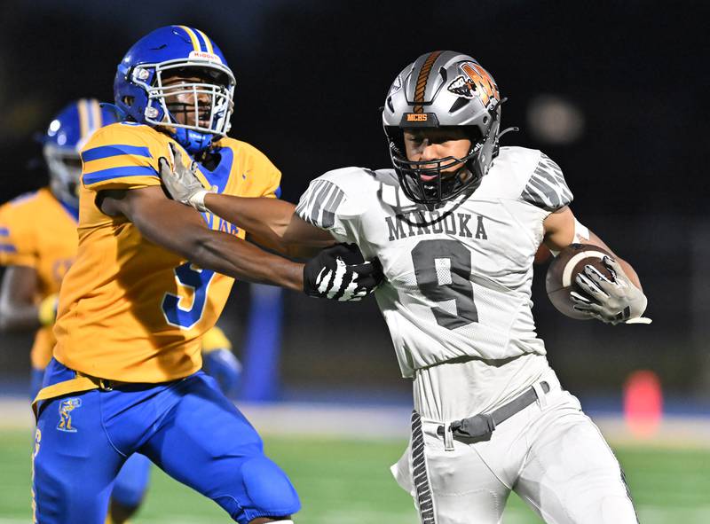 Minooka's Paris Spears stiff arms Joliet Central's Jotham Word   during a non-conference game on Friday, Sep 13, 2024 at Joliet. (Dean Reid for Shaw Local News Network)