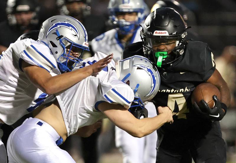 Sycamore's Tyler Curtis tries to get by two Woodstock tacklers during their game Friday, Sept. 8, 2023, at Sycamore High School.