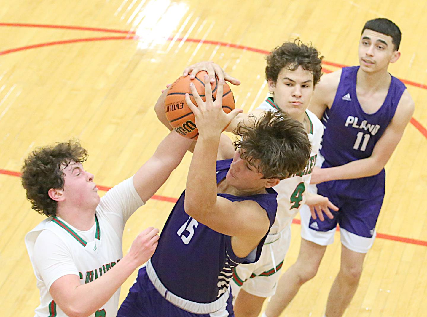 L-P's Tommy Hartman (5) and Plano's Kaleb Vedeckis (15) fight for a rebound as L-P's Jack Jereb (4) and Plano's Eric Cano (11) assist on Friday Dec. 2, 2022 in Sellett Gymnasium at La Salle-Peru Township High School.