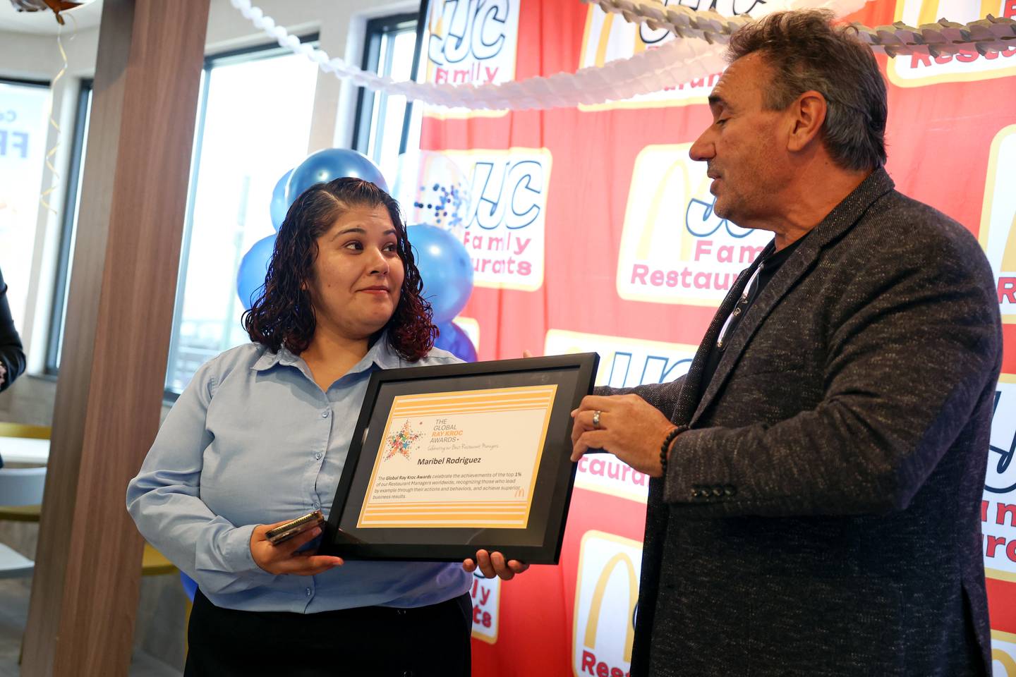 Kankakee resident Maribel Rodriguez, general manager of the North Fifth Avenue McDonald's, is presented with a Ray Kroc Award, by local franchisee owner John Carnagio, right, at the Kankakee location on Tuesday, Oct. 21, 2025. The recognition is presented to less than 1% of managers across the McDonald’s Corporation.