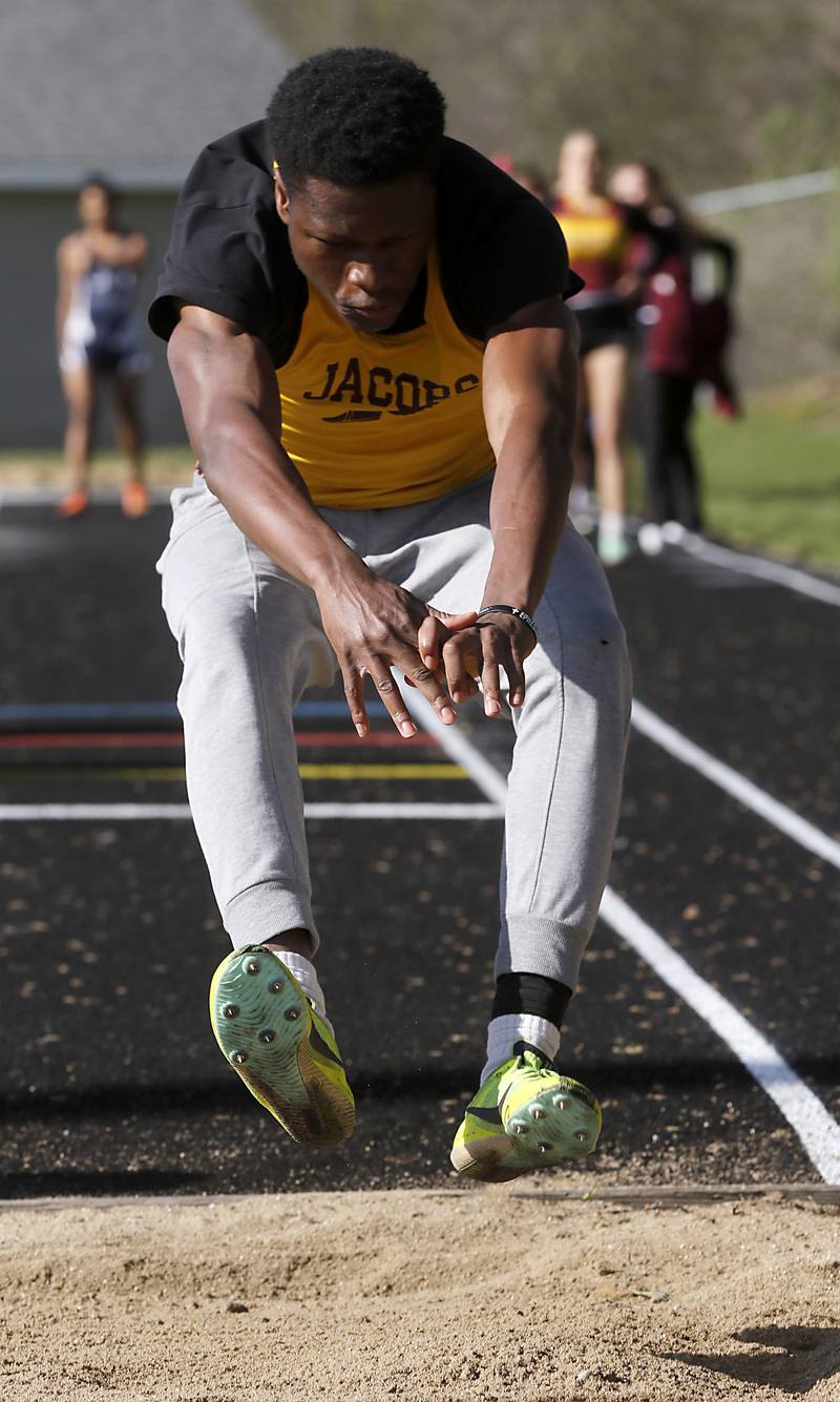 Jacobs’ Khristos Oludimu competes in the triple jump on Friday, April 19, 2024, during the McHenry County Track and Field Meet at Cary-Grove High School.