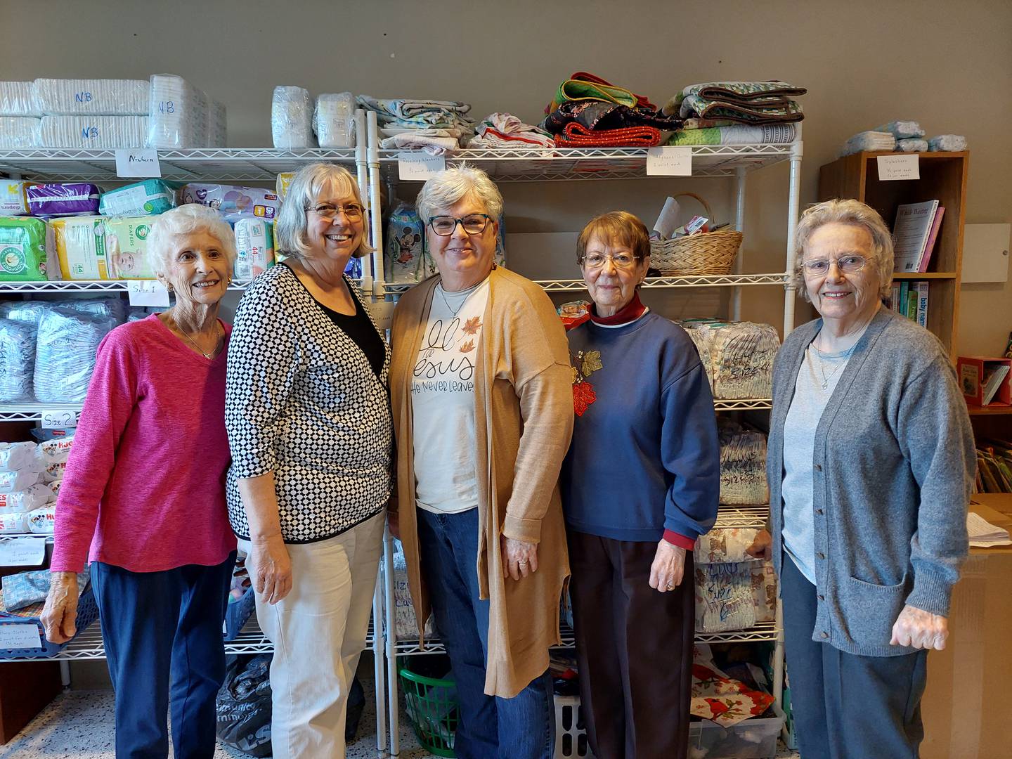 Guardian Angel Outreach volunteers (from left) Rita Houser, Linda Volkman, Vicki Vickers, Ruth Ann Robertson and Colleen Rithmiller help distribute diapers, clothing and other items to mothers of newborns.