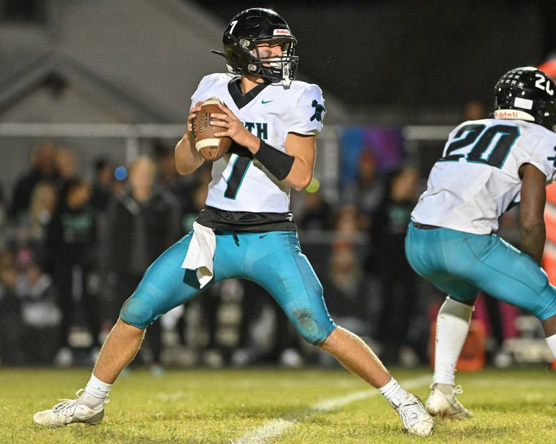 Woodstock North's Parker Halihan looks for an open receiver against Kishwaukee River Conference and crosstown rival Woodstock on Friday, Oct. 25, 2024 at Woodstock H.S.
