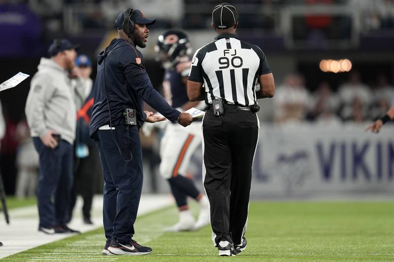 Chicago Bears interim head coach Thomas Brown, left, reacts after a pass interference penalty during the second half of an NFL football game against the Minnesota Vikings, Monday, Dec. 16, 2024, in Minneapolis. (AP Photo/Abbie Parr)