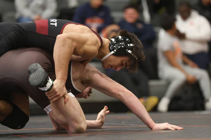 Lockport’s Chris Miller works over Joliet Catholic’s Vince Skedel in the Class 3A Minooka Regional 175 pound championship on Saturday, Jan. 31, 2026 in Minooka.