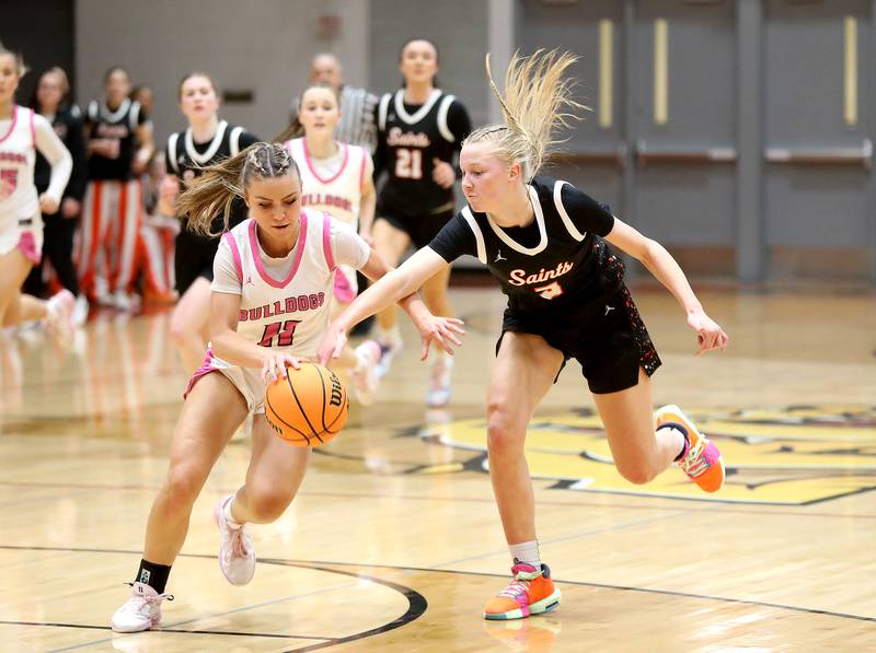 Batavia's Kaidyn King and St. Charles East's Brooklyn Schilb go after a loose ball during a game on Thursday, Feb. 6, 2025 in Batavia.
